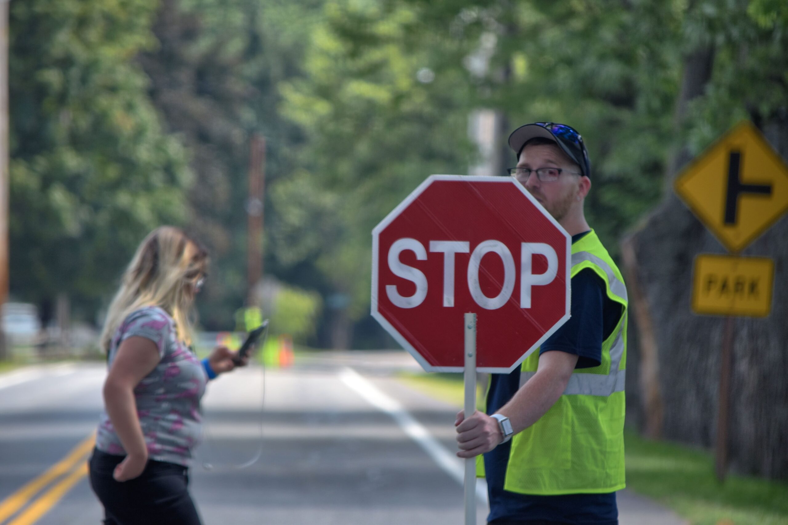 Community volunteer holding a stop sign