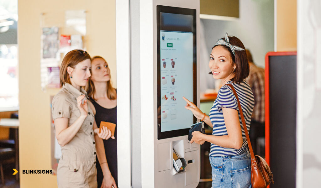 AI & Data-Driven Signage: How Smart Signs Improve Customer Experience 2 digital Signage used by a woman