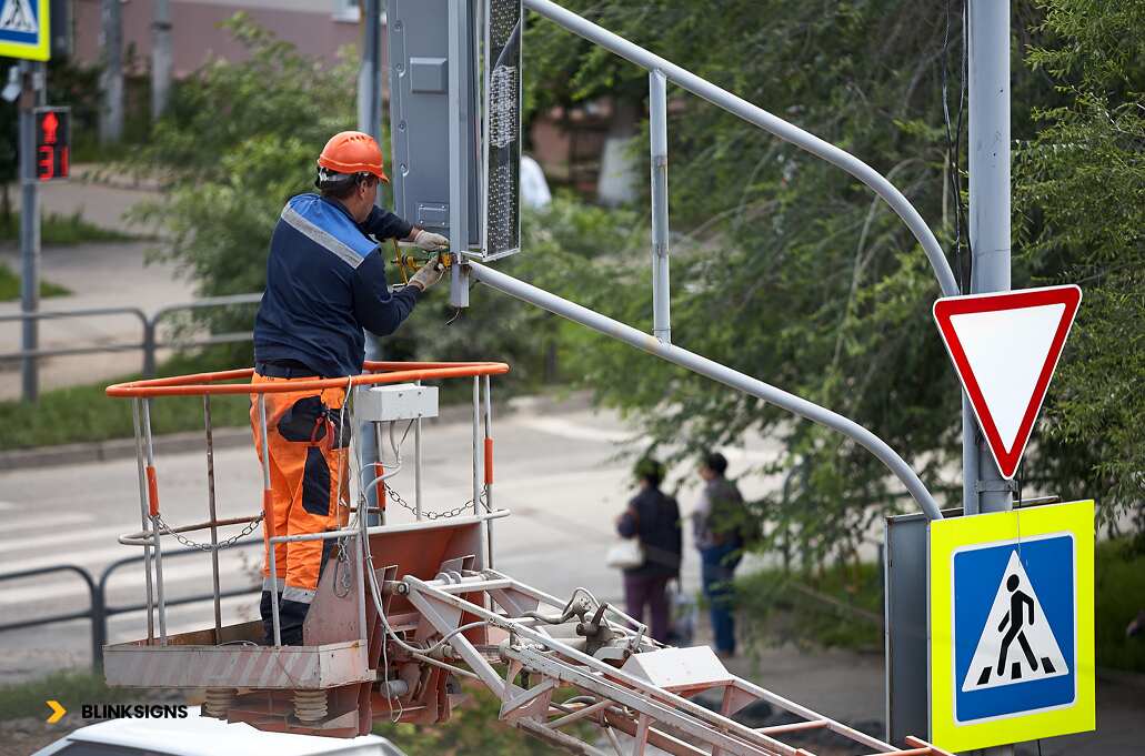 A person maintaining the sign boards