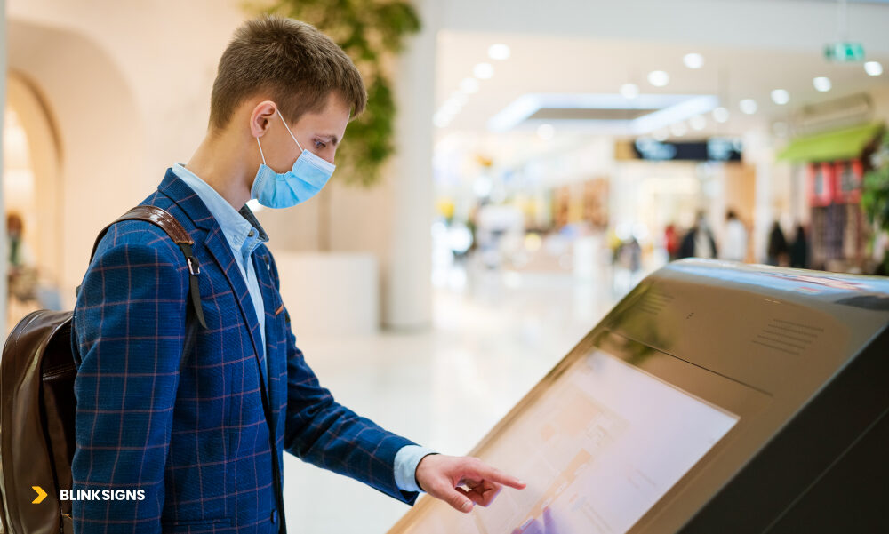 Digital Signage Trends: AI, Interactivity, and ROI-Driven Innovation 2 a boy using digital display