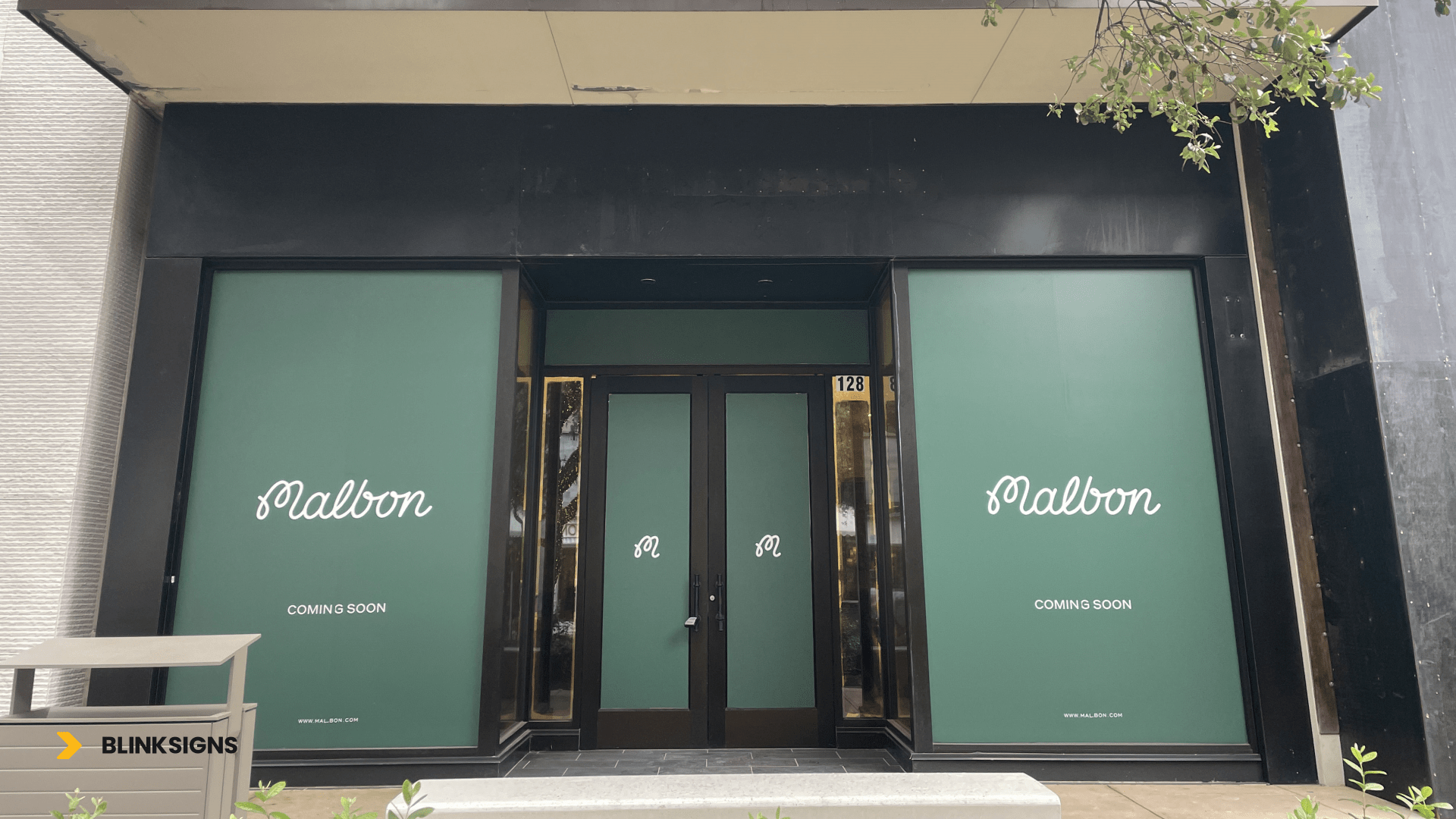 vinyl graphics of coming soon for malbon store iin texas