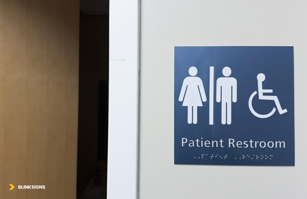 Wayfinding Accessibility: Designing Inclusive Navigation Systems for All Users 3 Restroom sign with male and female symbols with braille