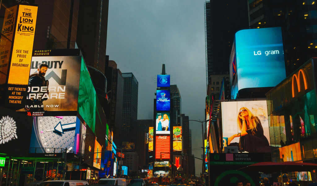 Programmatic DOOH Explained: A Complete Guide for Brands, Franchises, and Operators 3 digital signage on buildings of difference brands