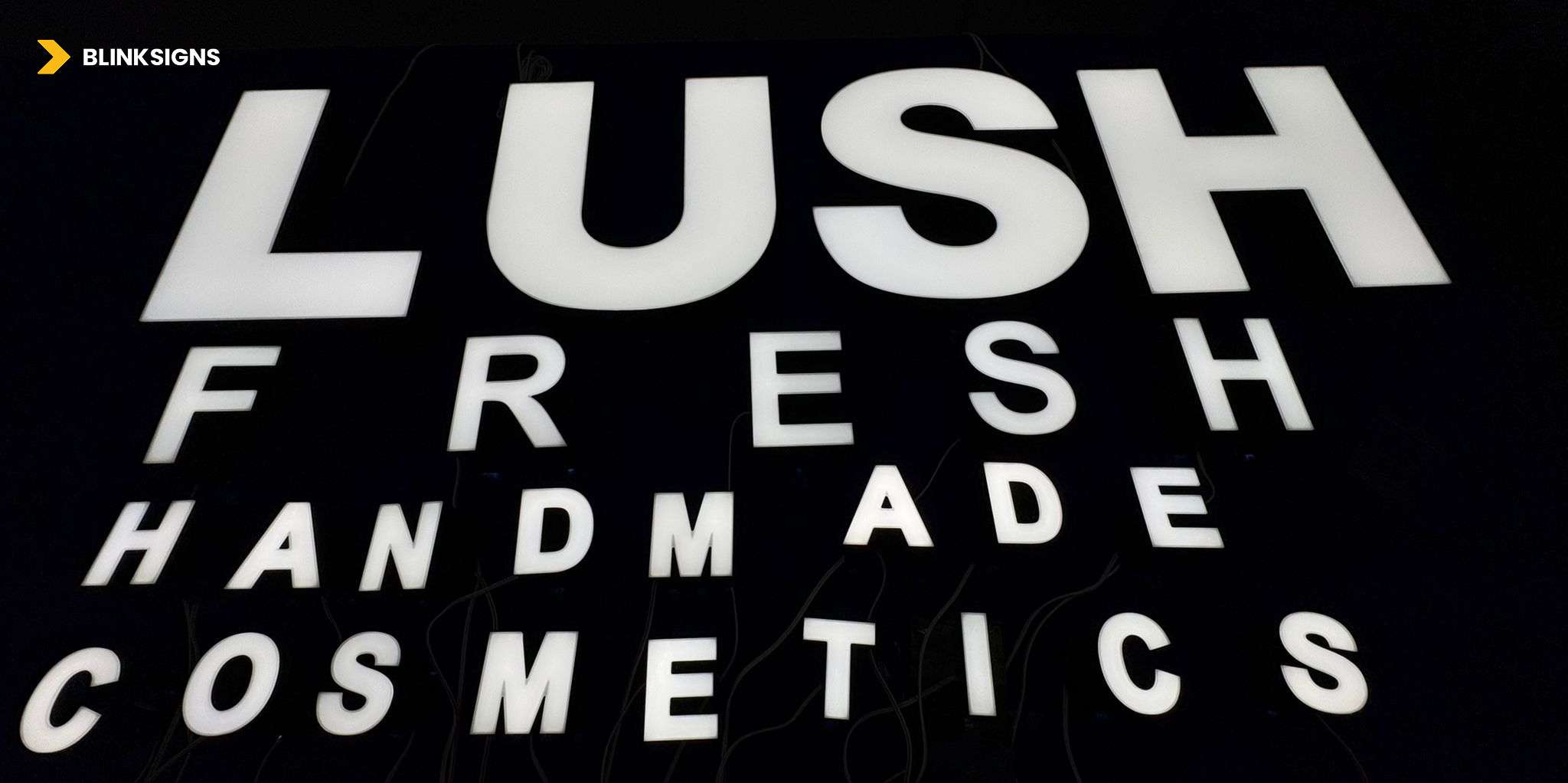 LUSH Fresh Handmade Cosmetics channel letters in a factory on a black background